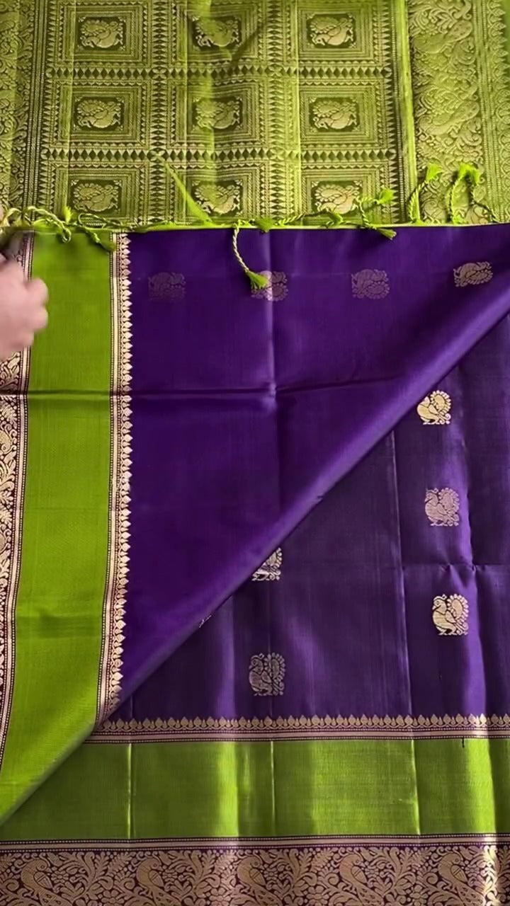 Green and purple fabric with intricate patterns on a textured background